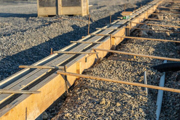 Construction photo of new running track slot drain in concrete.
