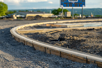 Construction photo of new running track slot drain in concrete.
