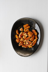 Peeled pecans on a saucer top view