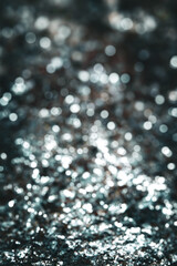 a black silver glitter abstract bokeh effect holiday or gala background. elegant festive celebration party design element with copy space