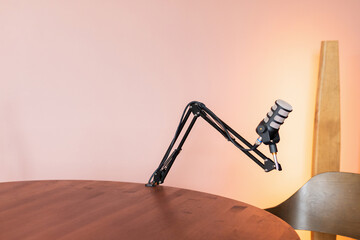 High-quality microphone setup on a wooden table ready for a podcast recording session in a cozy...