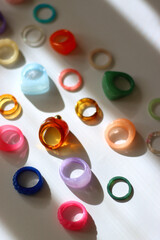 Collection of colorful plastic rings on white background. Selective focus.