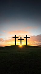 Three Silhouetted Crosses Against a Vibrant Sunrise Sky
