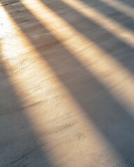Sunlight Rays Casting Shadows on a Smooth Concrete Surface