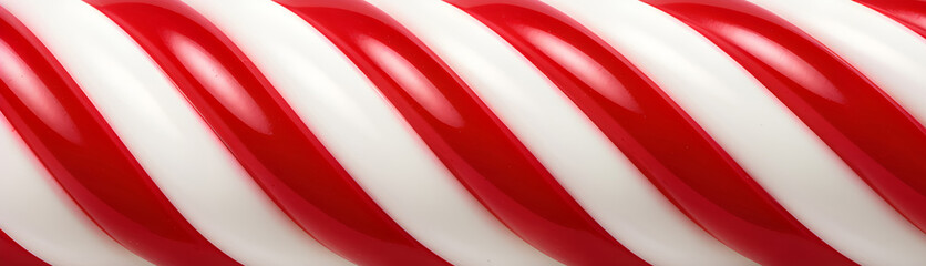 Glossy red and white peppermint candy stick background with vibrant diagonal stripes
