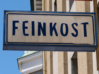 old historical sign with the German inscription: Feinkost, meaning a grocery store specializing in...