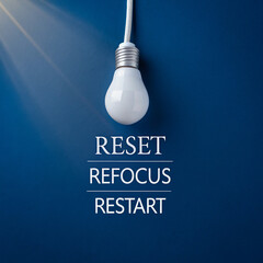 Bright white light bulb above motivational text on a clean blue wall, representing clarity, motivation, fresh start, and focus