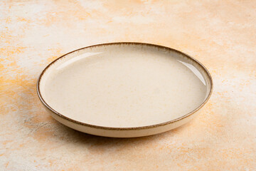 Empty Ceramic Plate on Rustic Stone Table. Minimalist Dining Concept