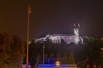 Illuminated medieval castle walls at night in Ljubljana