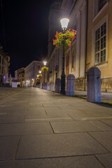Quiet streets of Ljubljana Old Town at night with lamps and flowers