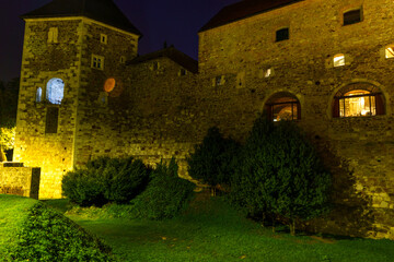 Illuminated medieval castle walls at night in Ljubljana