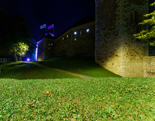 Illuminated medieval castle walls at night in Ljubljana