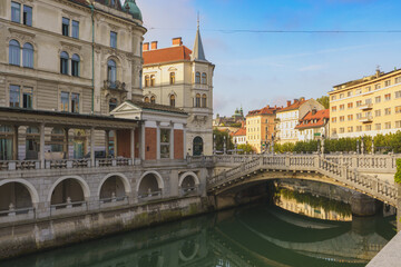 Ljubljanica river with historic bridges and market hall in Ljubljana