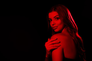 Obraz premium Photo of chic lady clubber feel tempting flirty touch hand shoulders over dark red neon color background