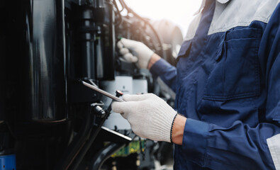 Mechanic with tablet computer control and fix problem of engine from industrial mining truck