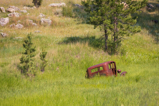 Old rusted car in a field