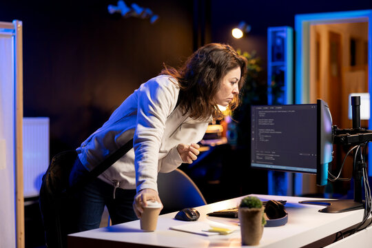 System administrator with disposable cup of coffee entering office to implement security measures, protecting company systems and data. IT expert starting job shift with hot beverage, testing code