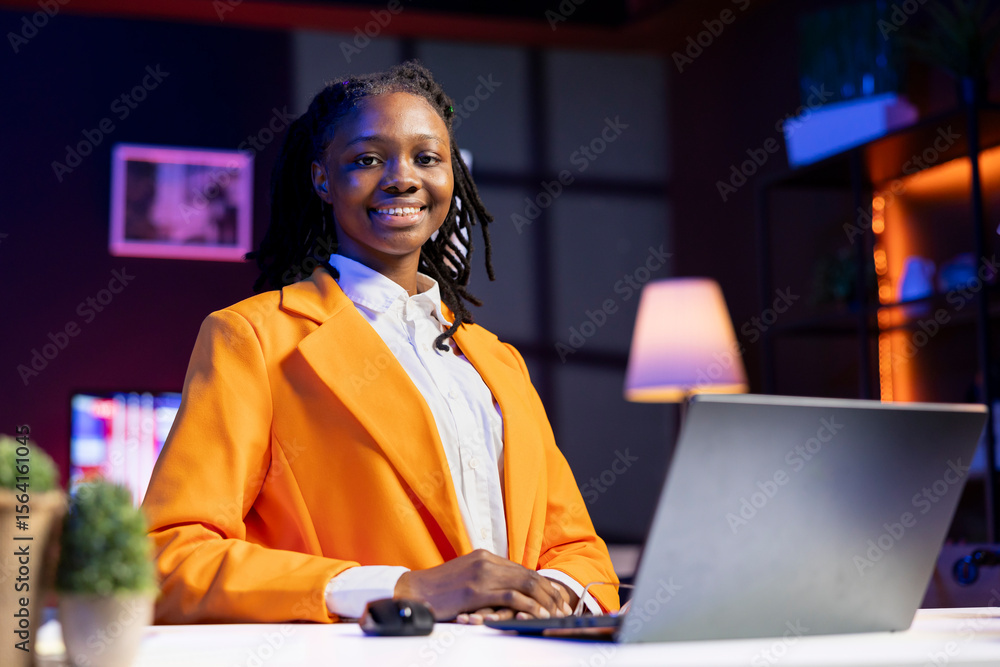 Poster portrait of smiling student at home browsing internet on notebook, doing homework, researching infor