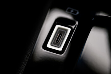 Close-up photo of the USB-C port on the dashboard of a modern car
