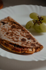 Close-up of Quesadilla with Grapes on Plate