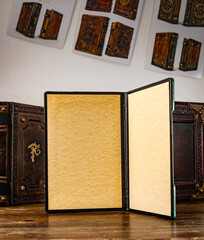 An old book in a room with other leather books