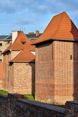fragments of medieval brick walls and towers in the city of Poznan