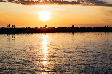 Naklejka premium Sunset Strollers on the Pier 