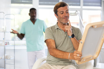 Male client is dissatisfied with results of rejuvenating procedure at cosmetologist and...