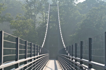 Shimane,Japan - June 28, 2025: A long suspension bridge over Oomaki river at Oni-no-shitaburui in Shimane, Japan at Sunrise
