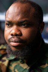 Obraz premium Focus on military operative deploying electronic warfare tools to disrupt enemy communication systems. African american soldier operating on high tech infrastructure, close up