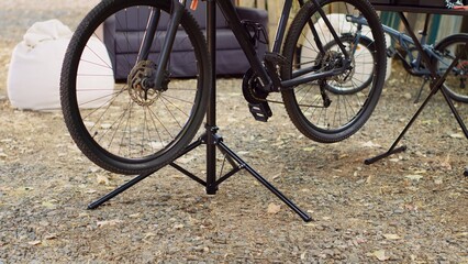 Detailed view of wheels of modern bicycle ready for thorough inspection and repairing as outdoor...