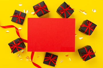 Mock up space with black gift boxes on color background, top view.Black Friday concept