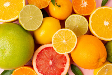 Different citrus fruits on wooden background, top view