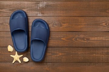 Blue sandals on wooden background,top view
