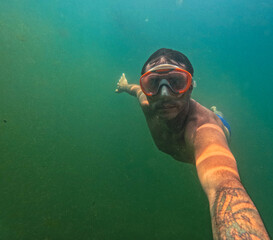 Swimming under water in Lake Levico, in Trentino, northern Italy, for a 40-year-old tourist. The...
