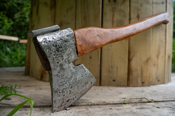 metal axe near wooden wall - close-up.