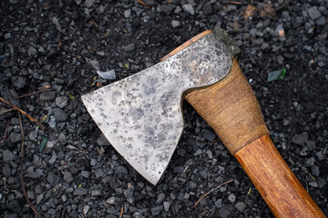   metal axe lies on the charcoal.