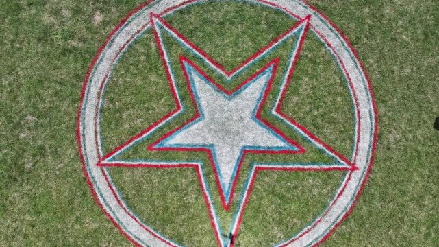  Aerial Top-Down View of Seven Gables Lawn with Stars of Red, White, and Blue Flags for Fourth of July Celebration&rdquo;