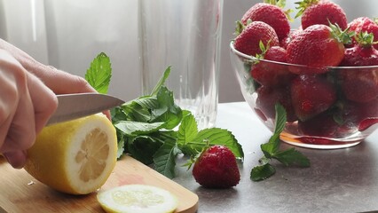 woman making refreshing homemade lemonade detox drink or cocktail summer with ice. Refreshing...