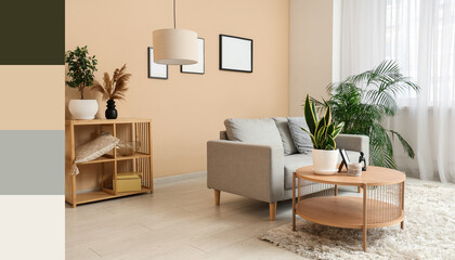 Stylish living room with cozy sofa, houseplants and blank picture frames on beige wall