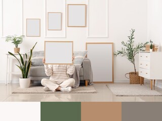 Young woman with frame sitting on floor in modern living room. Different color patterns