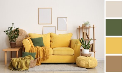 Yellow sofa, basket with plaid, cushions and frames on white wall in living room. Different color...