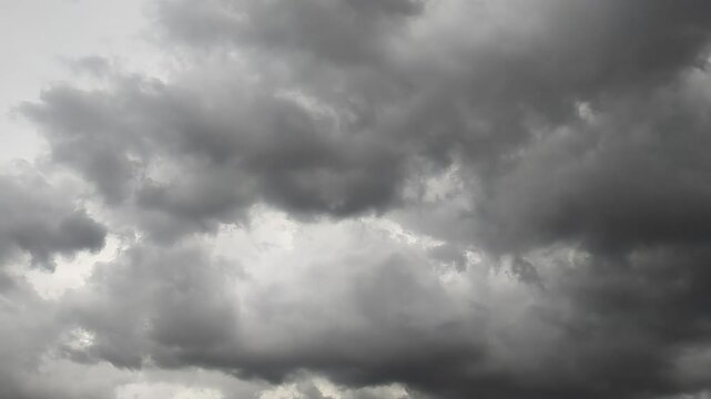 Ominous cloudscape background of gray puffy clouds on a dark and overcast windy day