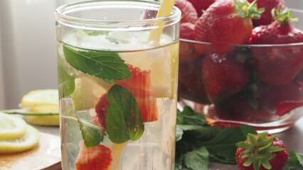 woman making refreshing homemade lemonade detox drink or cocktail summer with ice. Refreshing...