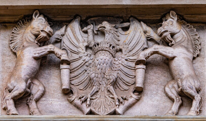 Medieval stone panel with unicorns and royal coat of arms