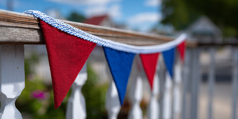 A garland of American flags on the railing of the house.