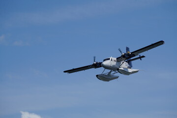 A Harbour Air plane flying in the sky in Victoria, Canada