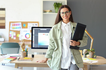 Female interior designer with graphic tablet in office