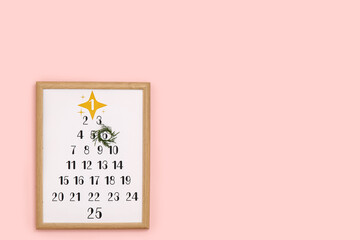 Christmas calendar on pink wall