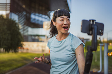 Japanese woman blogger record video for v-log and show outdoor gym